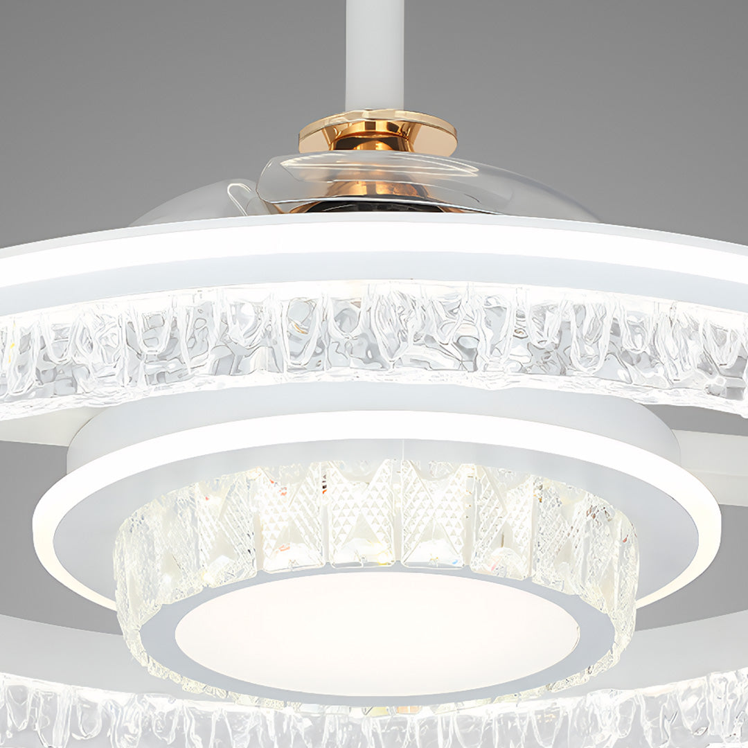 Close-up of the hidden retractable fan blades and the two-tiered crystal core of the ceiling fan with round light fixture. 