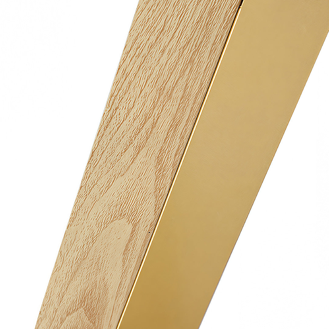 Close-up detail of the smooth gold metal and textured light wood grain on the linear led wall light surface.