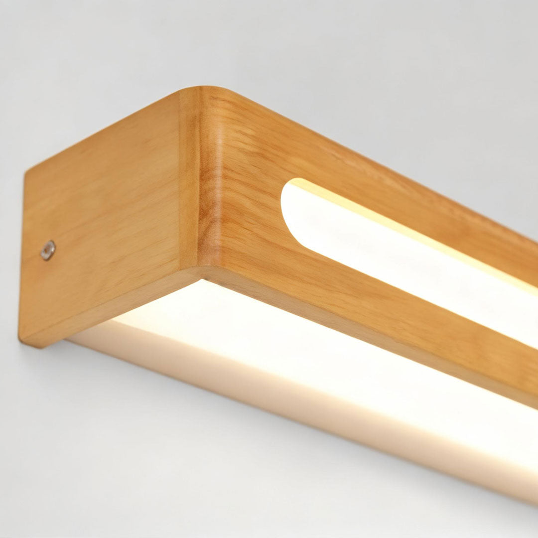 Close up of smooth wood finish on a vanity mirror light fixture.