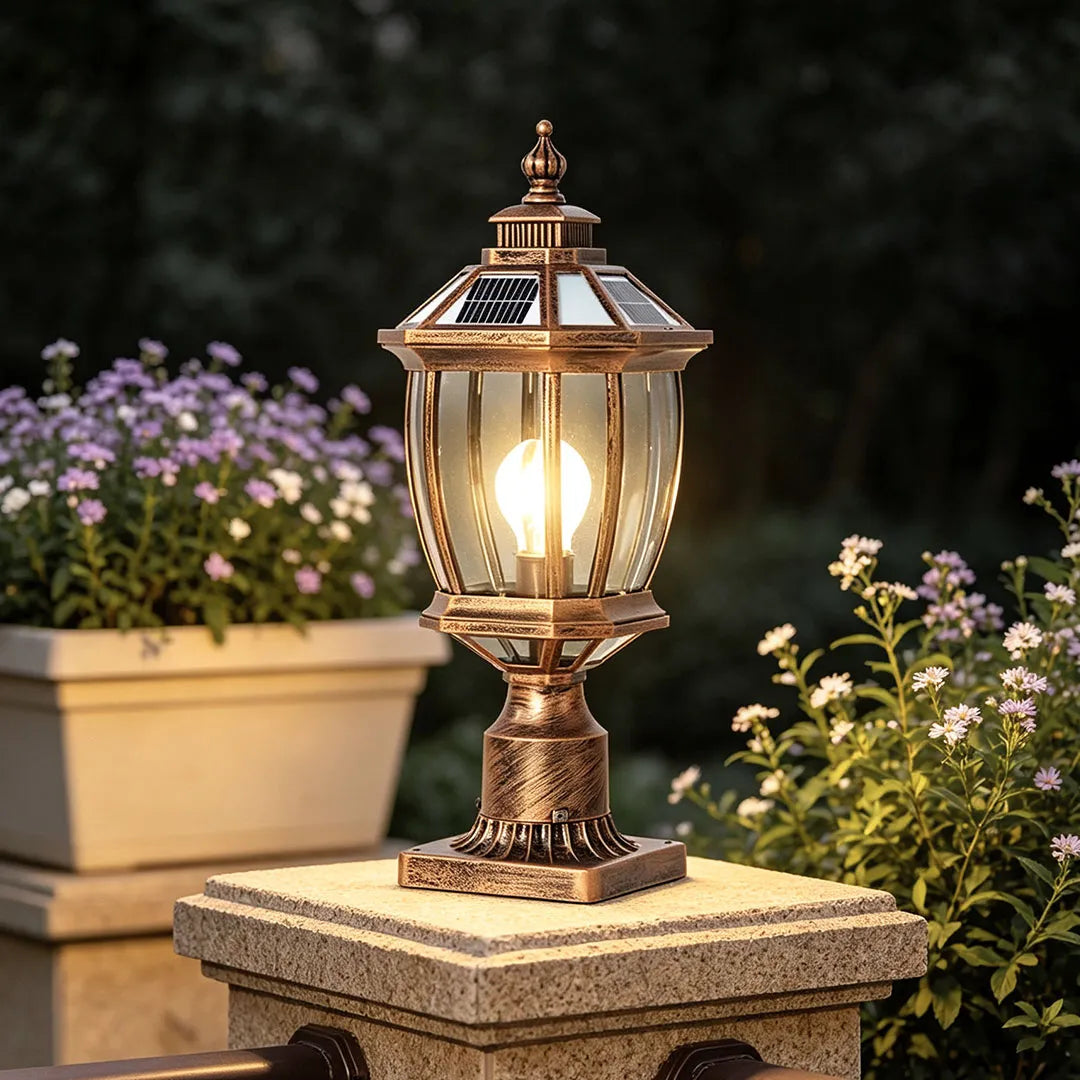 Close-up of a solar column pillar light with a bronze finish on a stone cap.