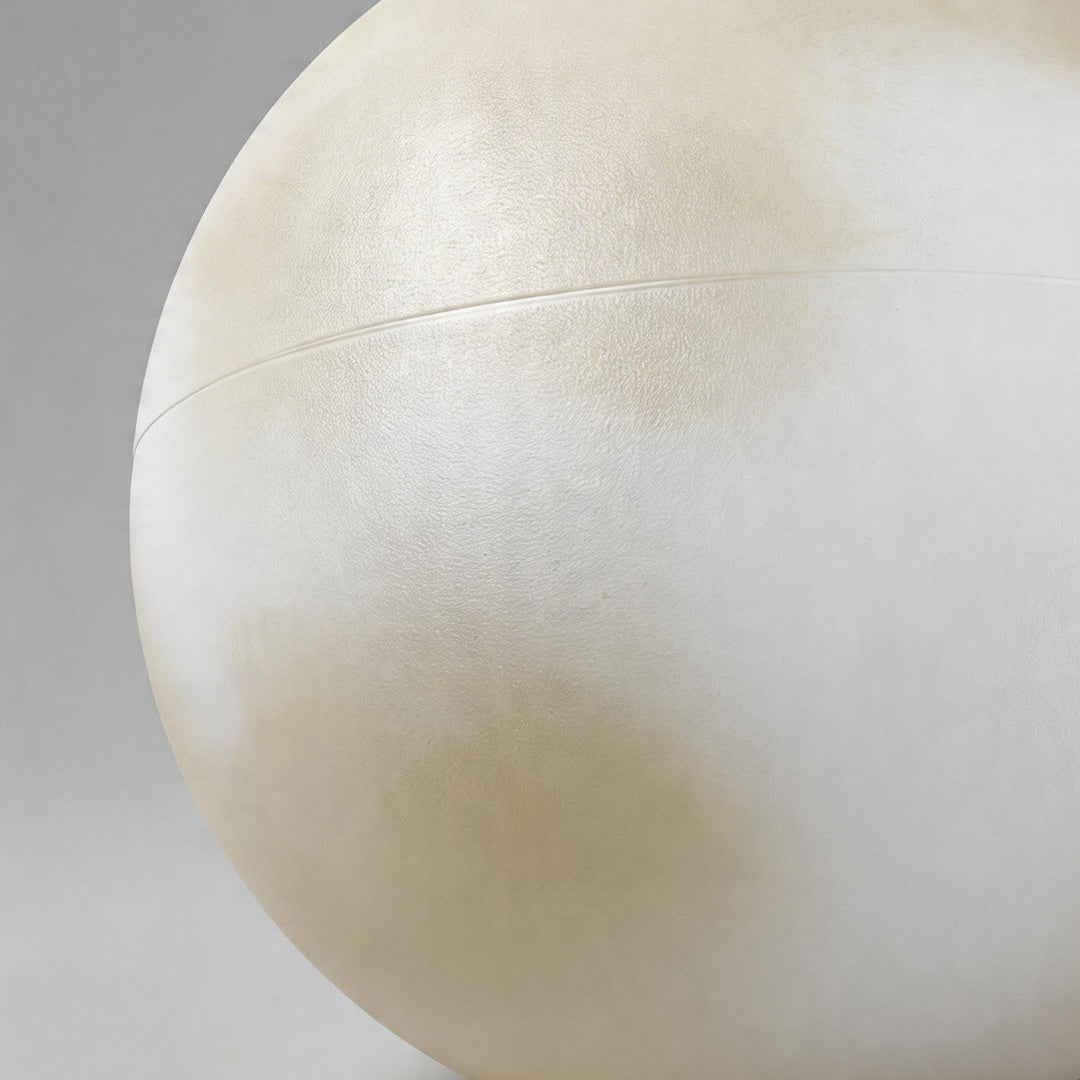 Close up of the spherical surface and material finish of moon pillar lights in a studio shot.