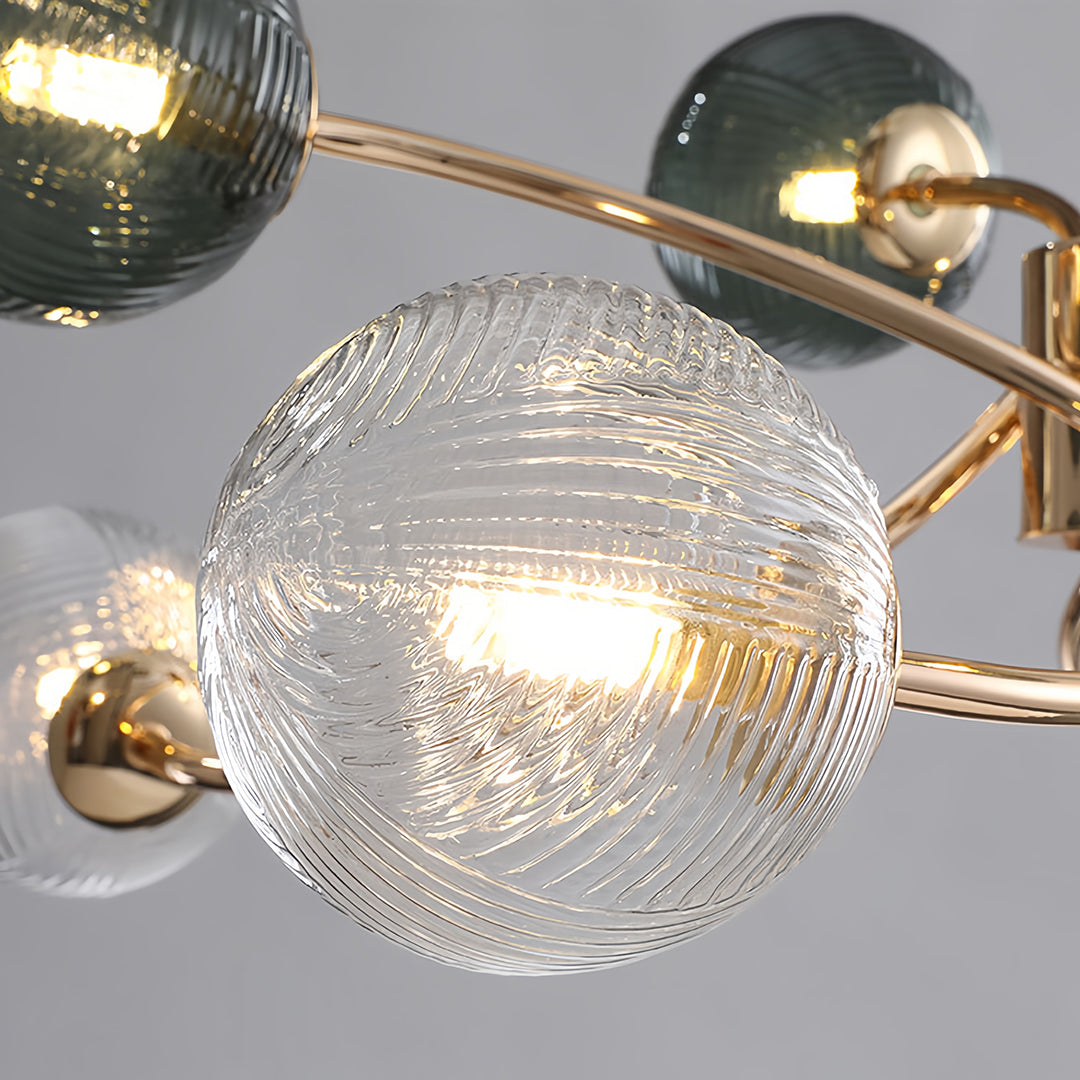 Close-up detail of the striated clear glass globe on the flush mount ceiling light, illuminated from within.