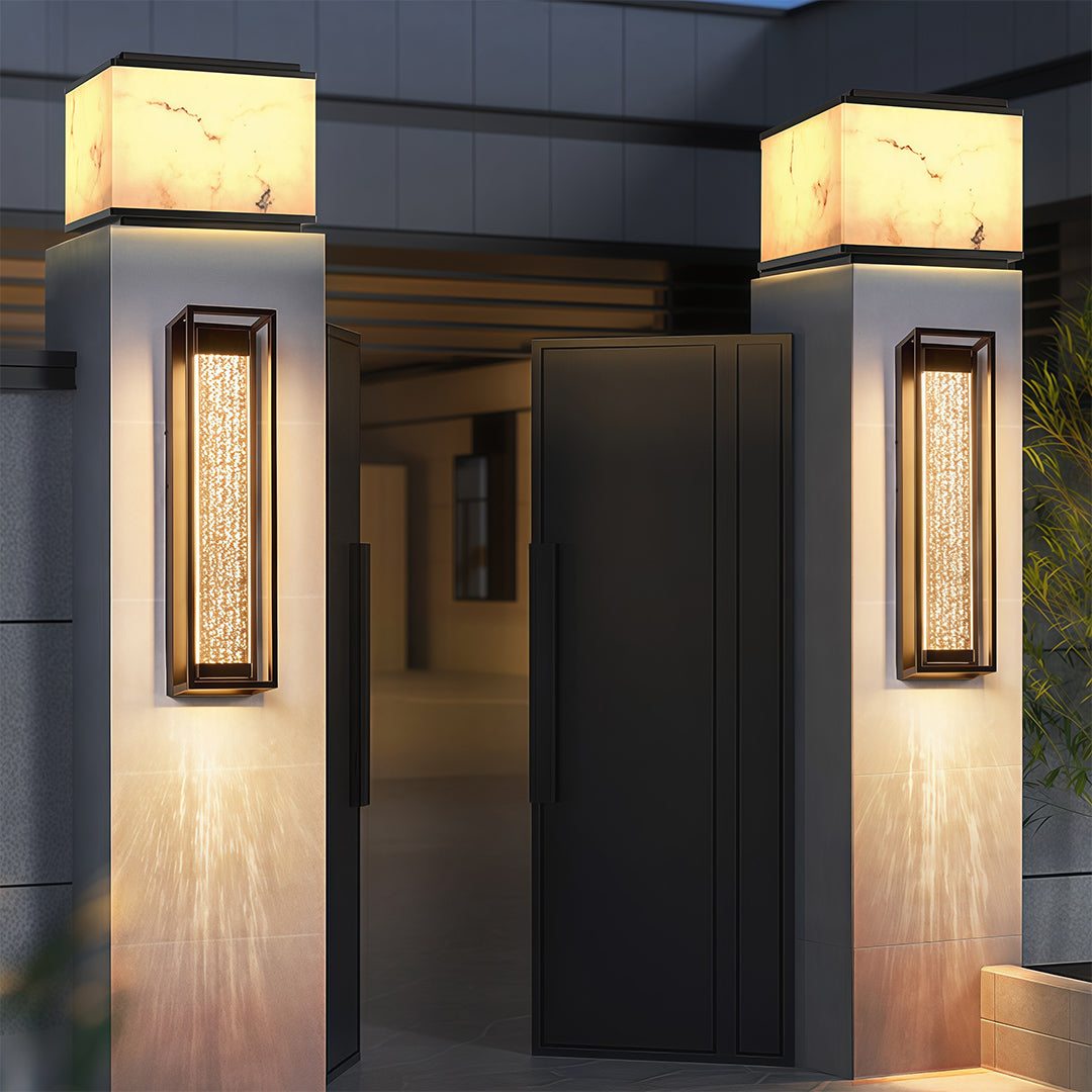 Black outdoor sconces with a close-up view of the textured glass, showcasing its unique design details.