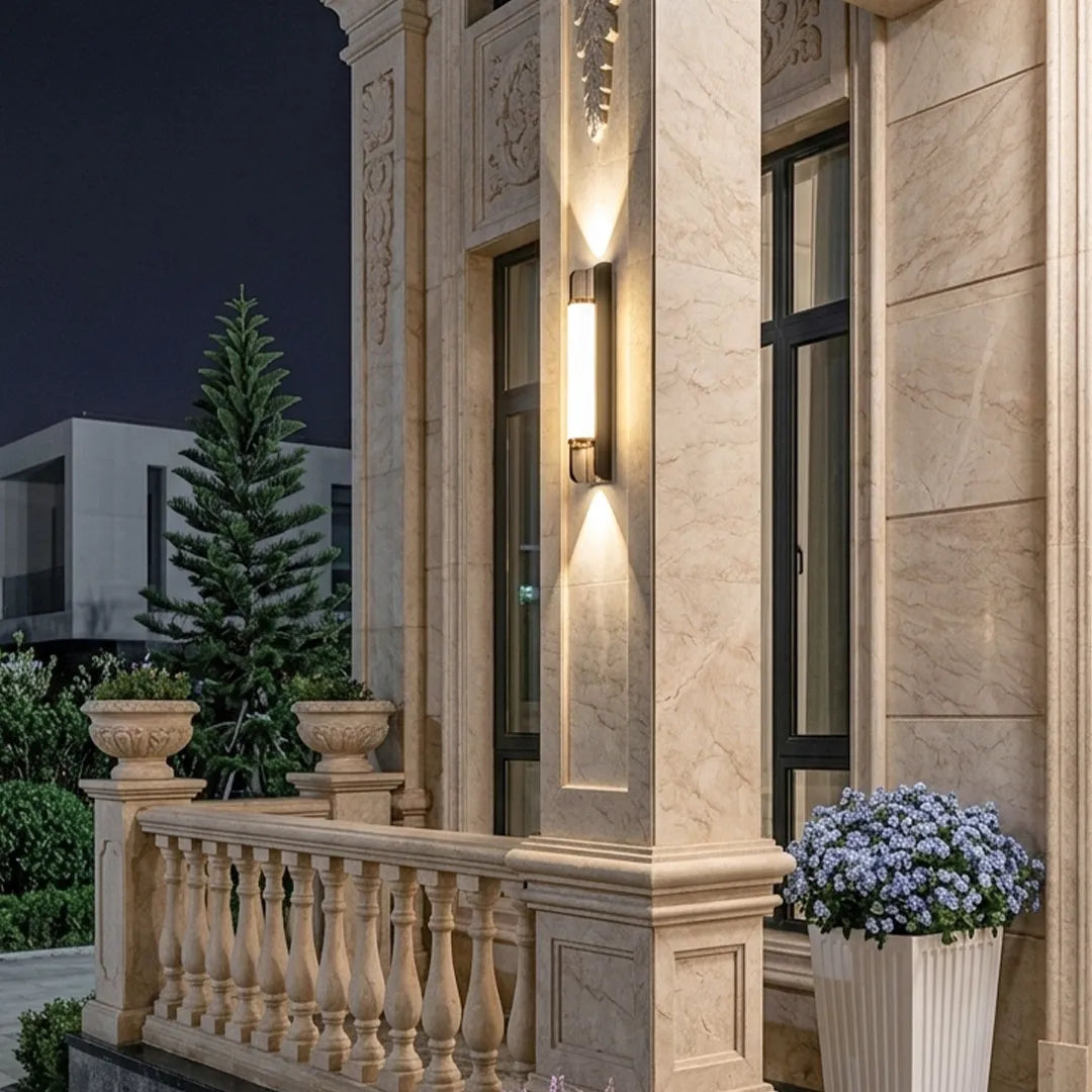 Close-up of up down outdoor wall sconce showing the bronze trim and frosted diffuser.