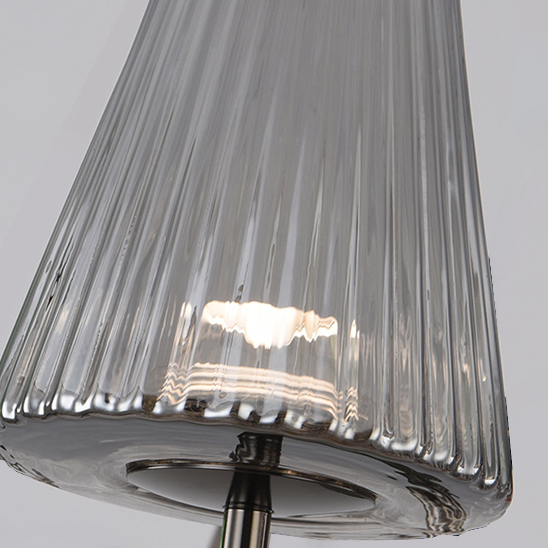 Close-up of the vertical pleated glass texture on elegant table lamps with a modern finish.