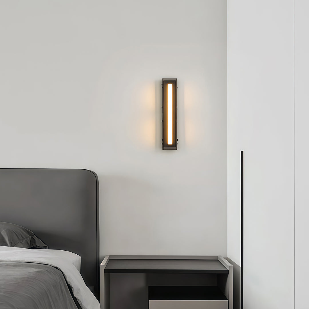 Close-up of a modern wall light decoration, highlighting the black and gold finish and design.