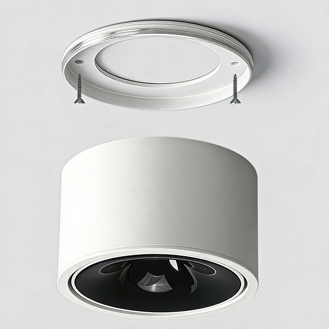 Close-up view of a white ceiling spotlight with black interior and sleek design.