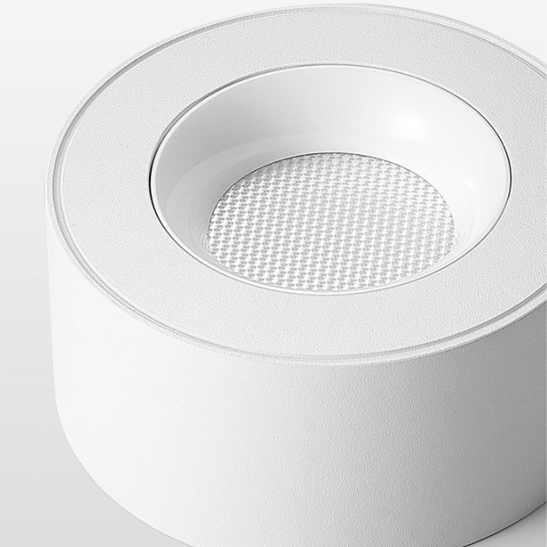 Close-up of a white surface mounted can light showcasing its sleek finish and clean design.