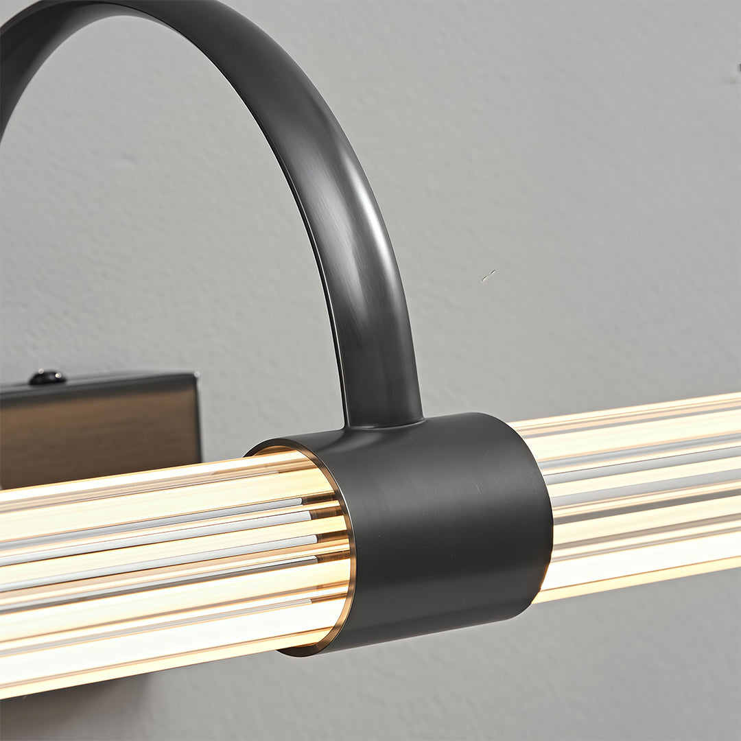 Close-up detail of bathroom vanity wall light showing curved black arm and textured LED light bar.