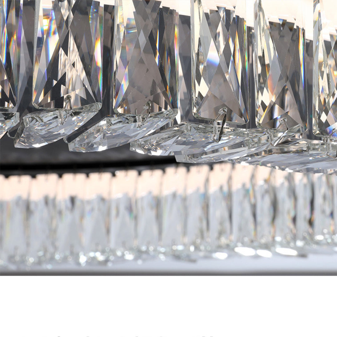 Close-up detail of black ceiling flush mount light showing layered crystal prism construction and metallic finish.