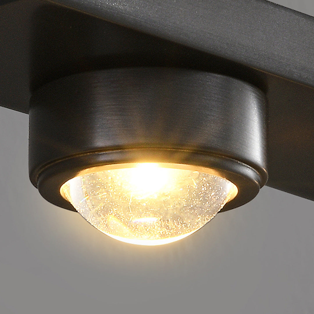 Close-up detail of black vanity lights for bathroom showing individual spotlight with warm LED illumination