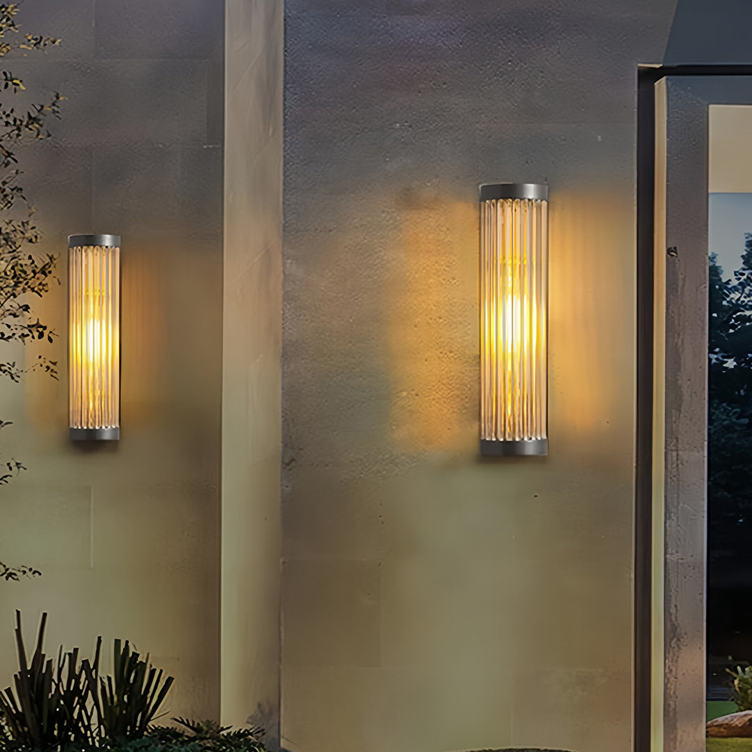 Close-up view of the brushed metal cap and ribbed glass diffuser on the modern outdoor wall LED light fixture.