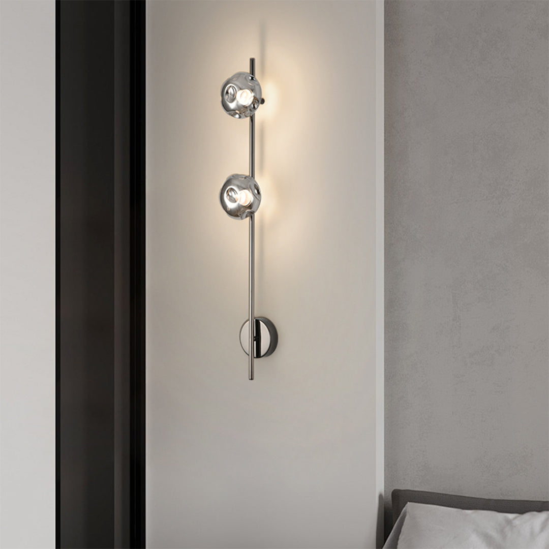 Close-up detail of indoor wall mounted lights showing chrome finish with circular mounting plate