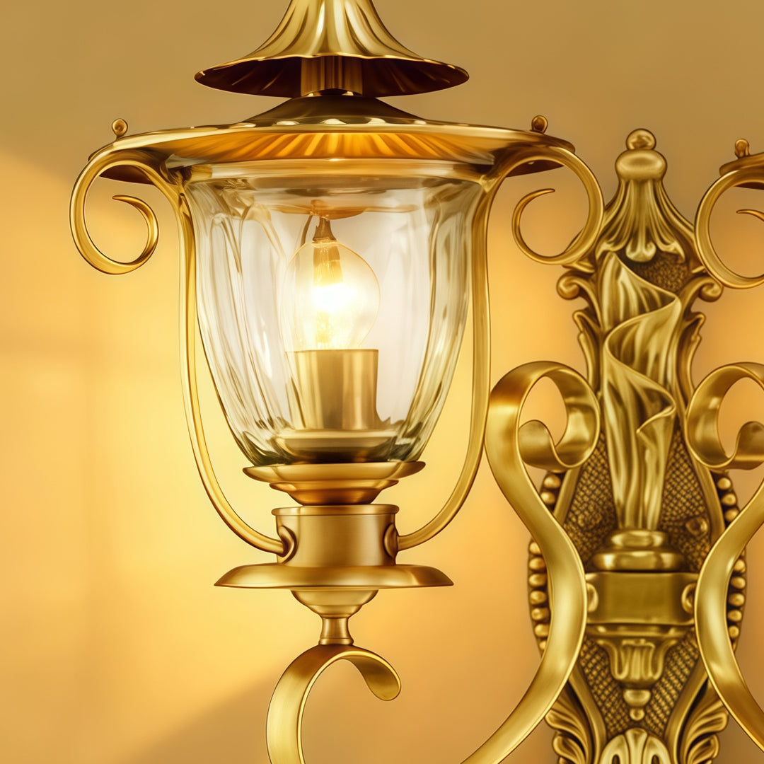Close-up view of luxurious Copper Outdoor Wall Sconces with curved decorative arms and clear glass lantern shade.