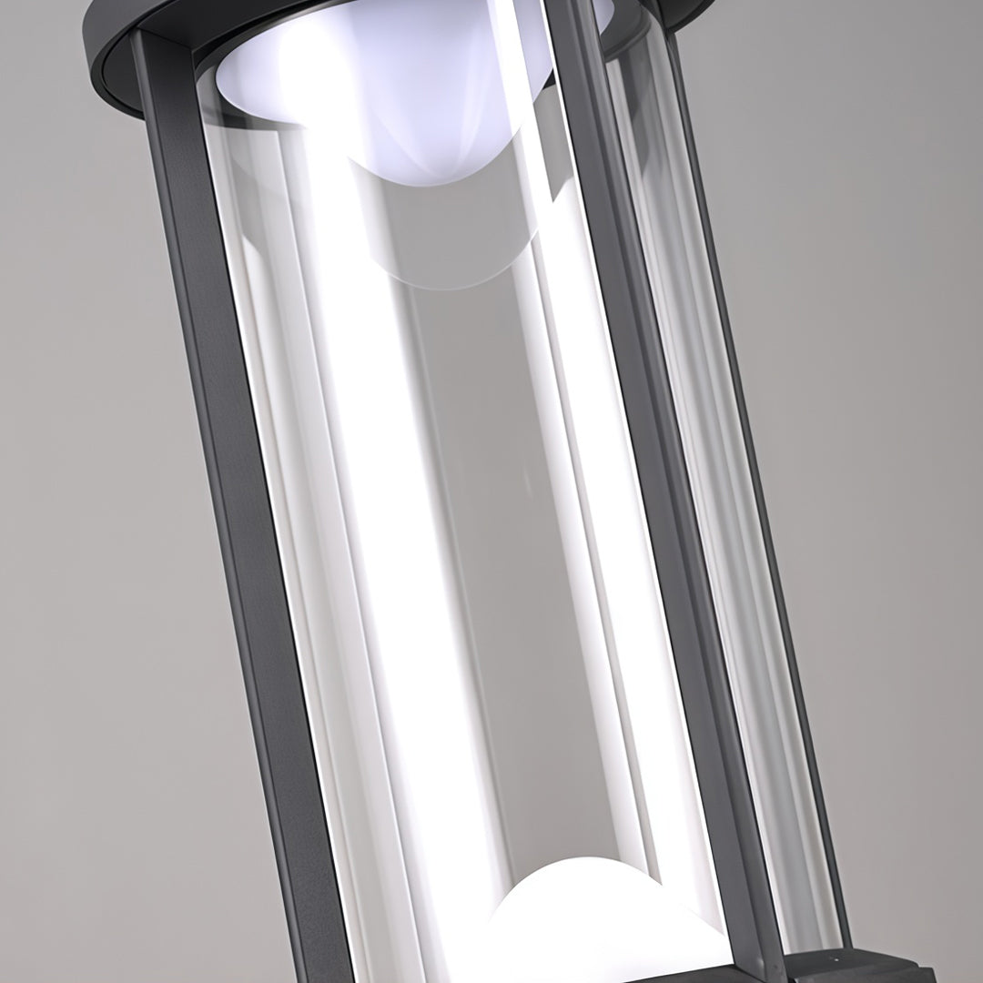 Close-up detail of modern cylindrical Landscape Bollard Lights with transparent glass housing and integrated LED bulb.