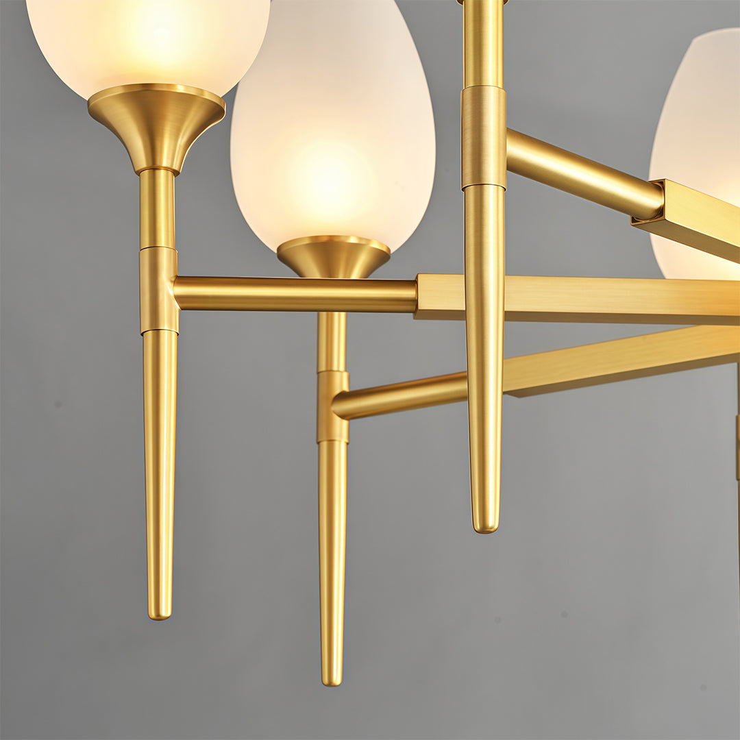 Close-up detail of glass modern chandelier featuring glass shade chandelier design highlighting brushed brass construction and frosted glass shades.