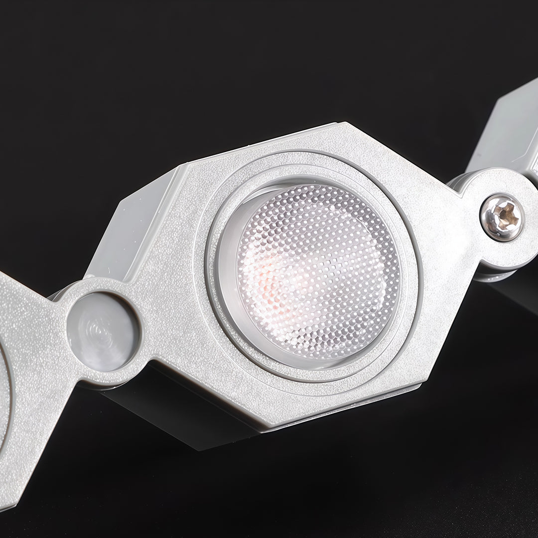 Close-up of DIY wall wash lighting component with glass shade chandelier inspired LED module showing technical construction detail.