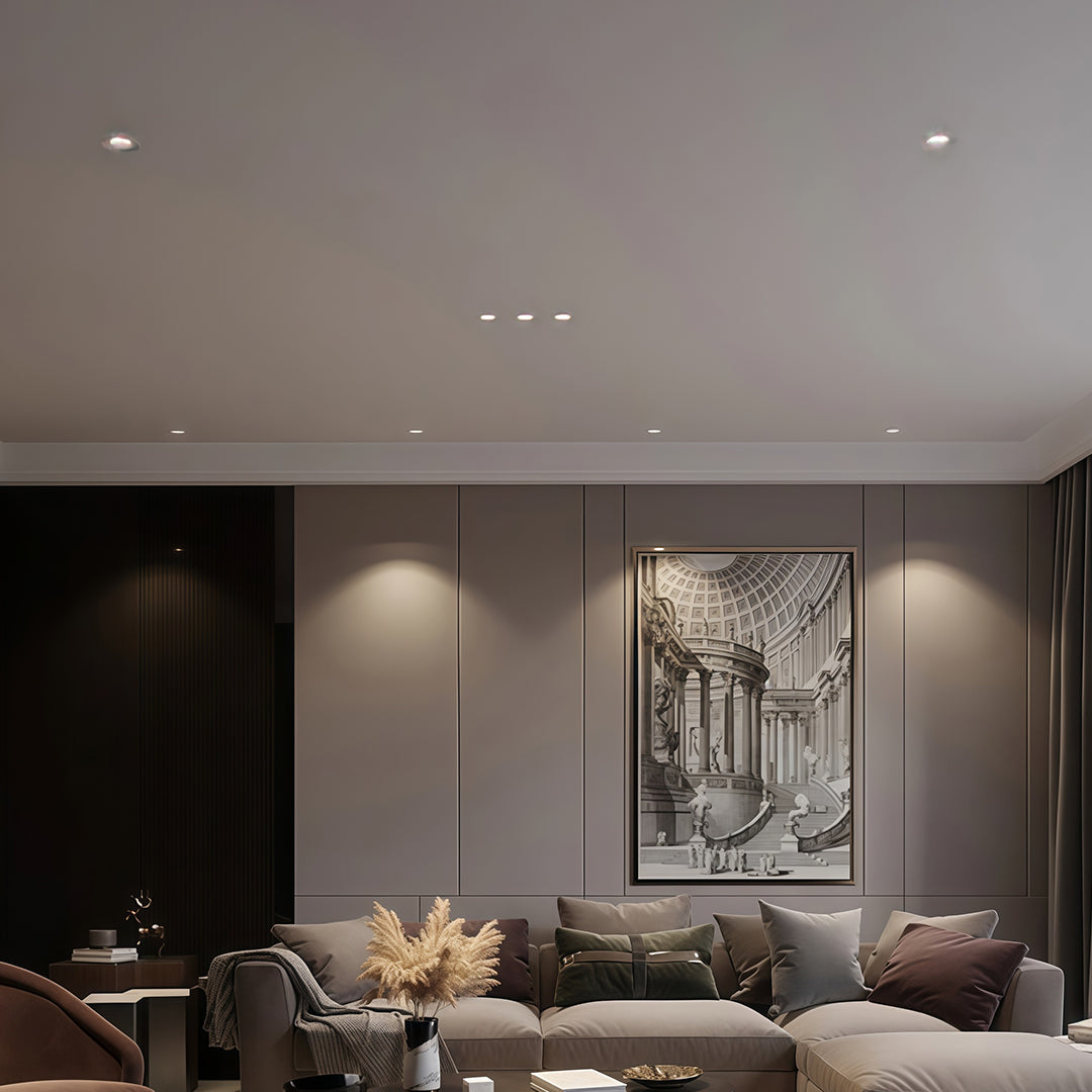 Close-up of flush mount spotlights with glass shade chandelier inspired white trim and angled black reflector detail.