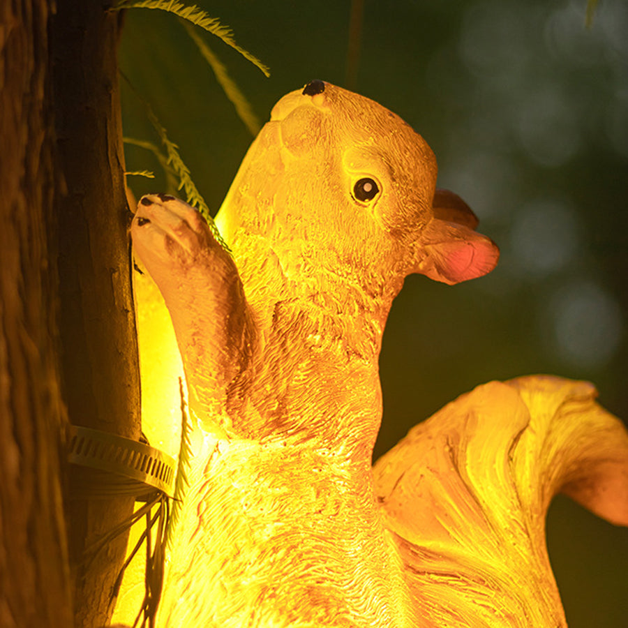 Close-up view of illuminated golden squirrel solar light showcasing detailed craftsmanship and warm glow