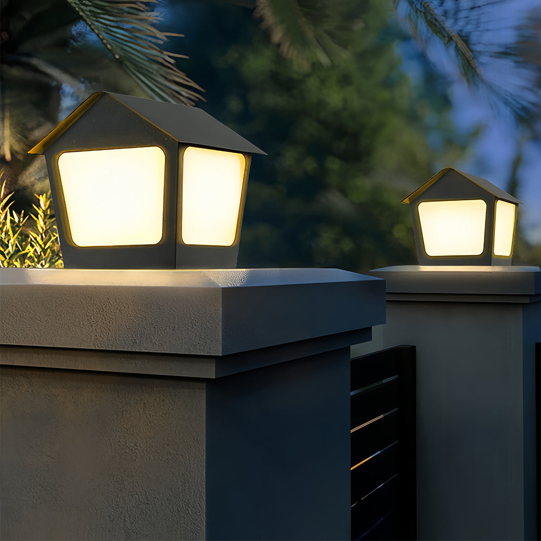 Close-up view of the house-style diffuser on the outdoor deck post cap lights against a dark night backdrop.