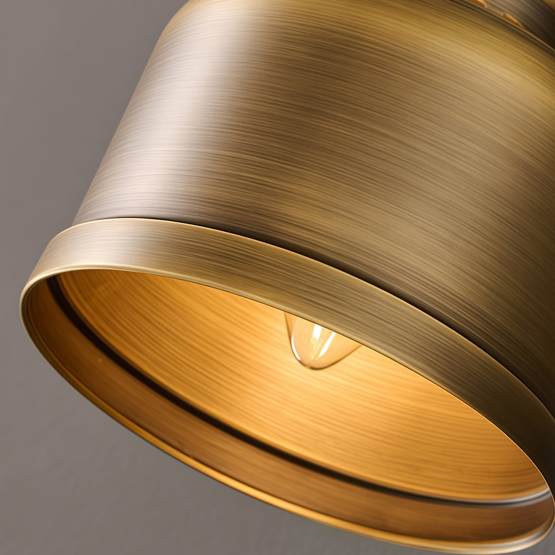 Close-up of LED wall light lamp with glass shade chandelier styling showing brass bell shade interior with warm glow.