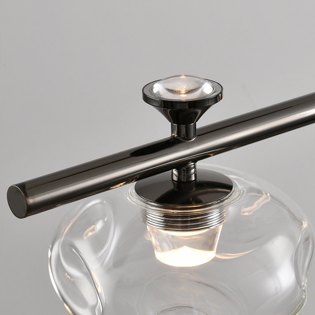 Close-up detail of linear glass chandelier showing transparent glass spheres with LED illumination