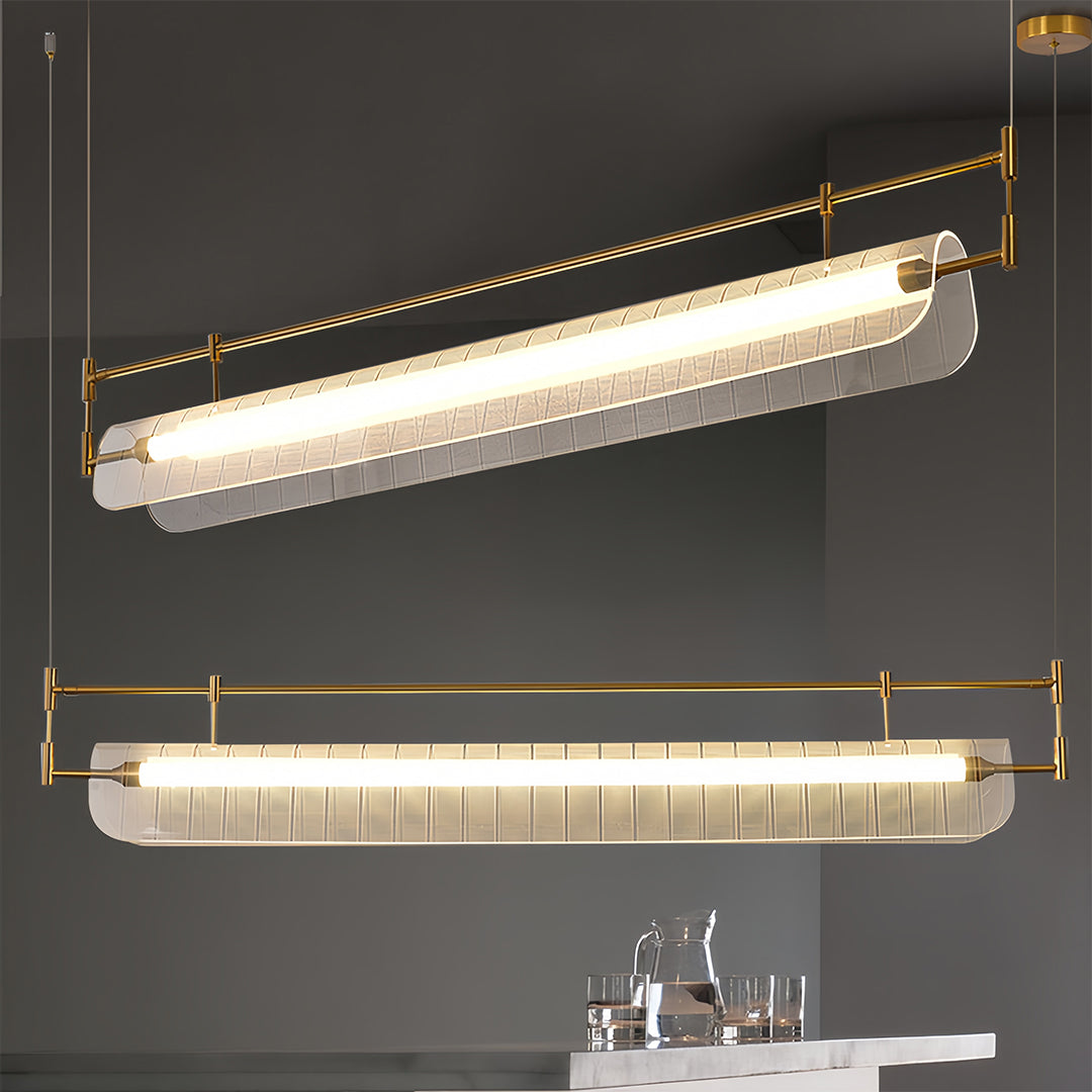 Close-up of linear light pendant showing detailed glass texture and warm LED illumination.