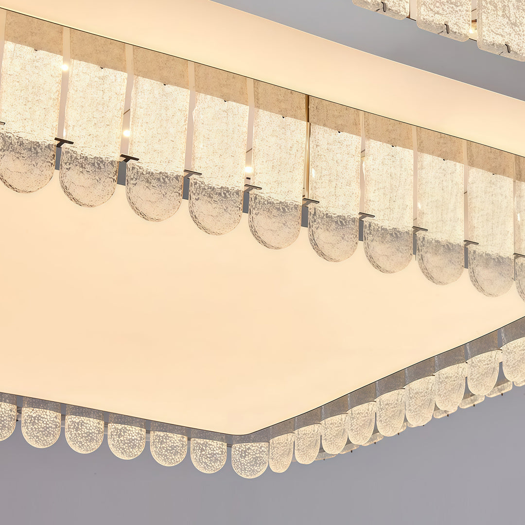 Close-up detail of modern flush mount light fixtures showing glass shade chandelier inspired multi-layer crystal construction.