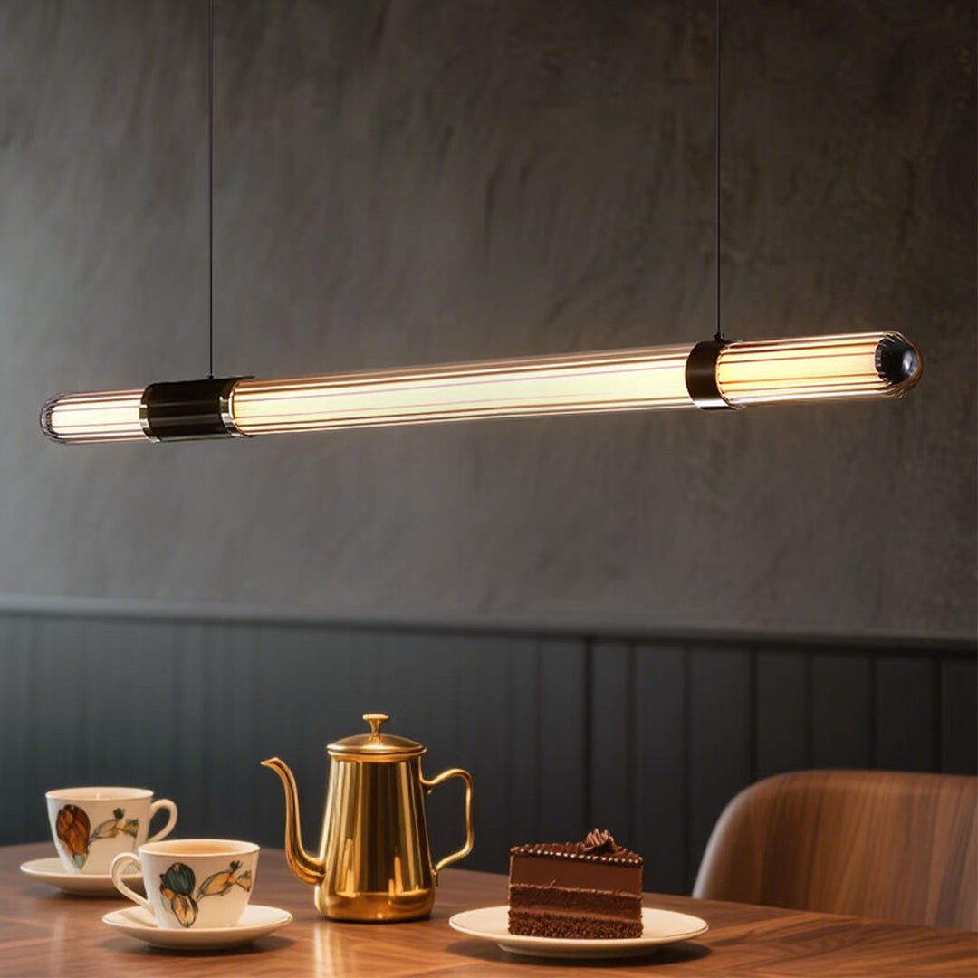 Close-up of glowing modern linear suspension lighting tube with warm ribbed glass texture.
