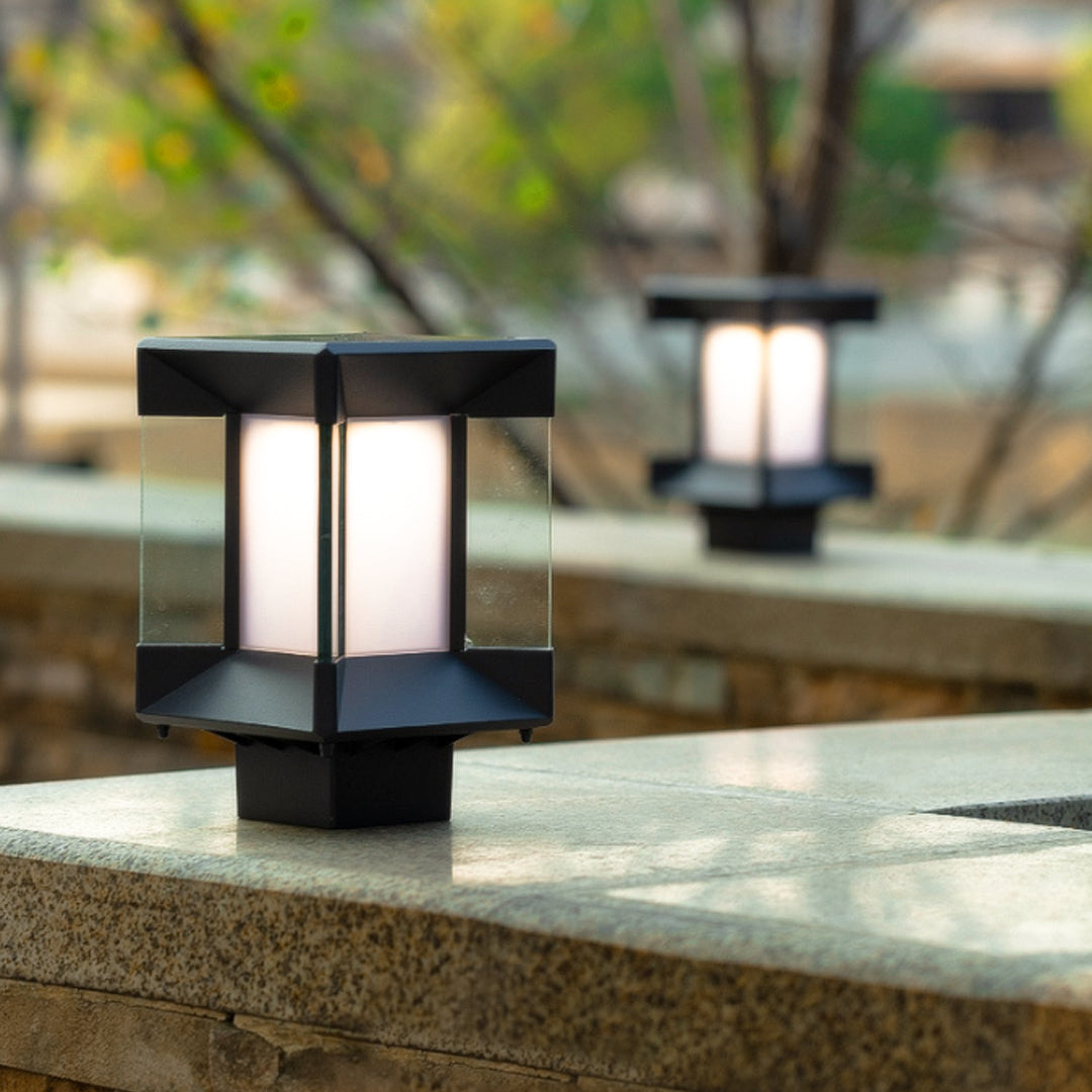 Close-up of pillar lights outdoor modern with frosted glass and black square top.