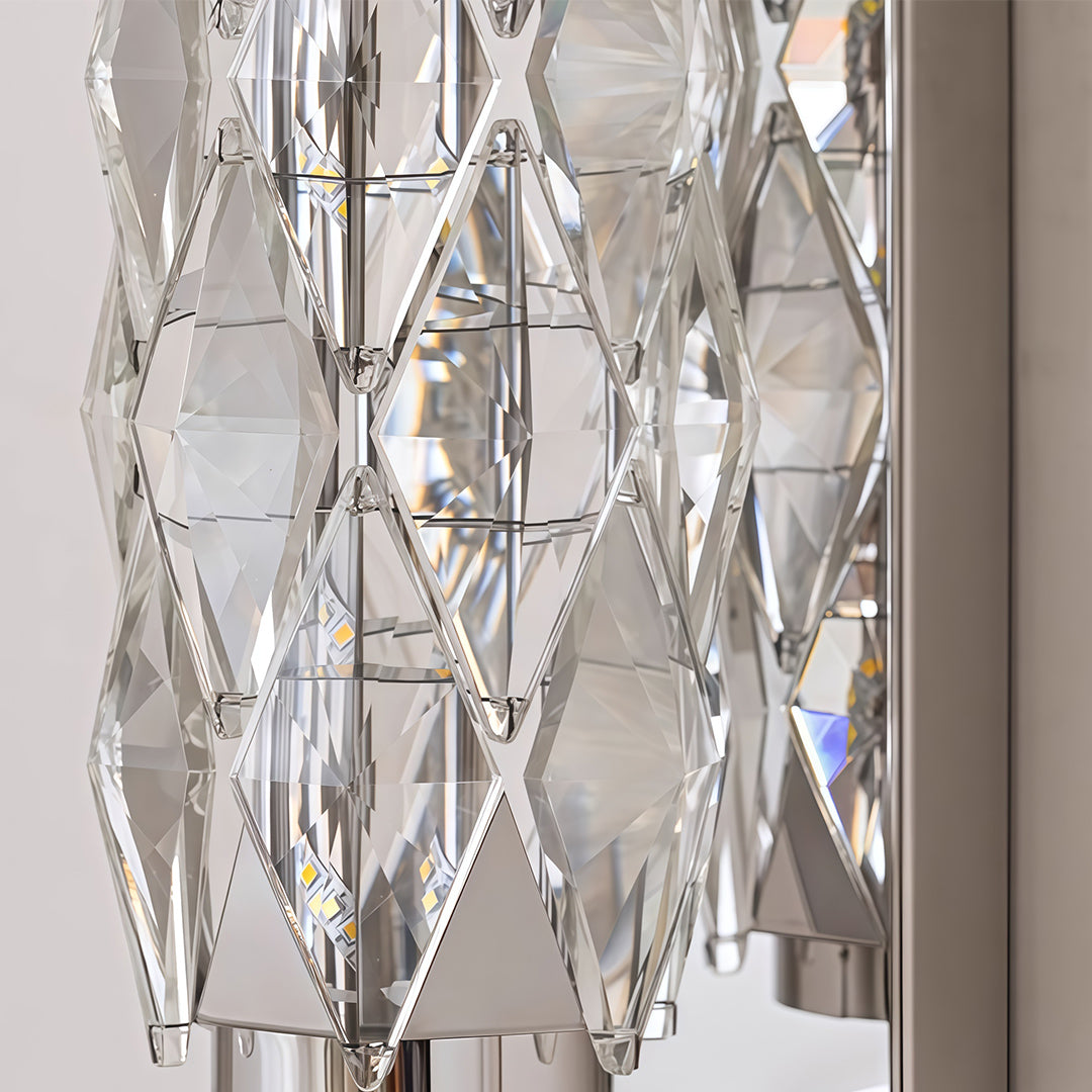Close-up detail of modern wall light showing intricate crystal pattern texture on white backdrop.