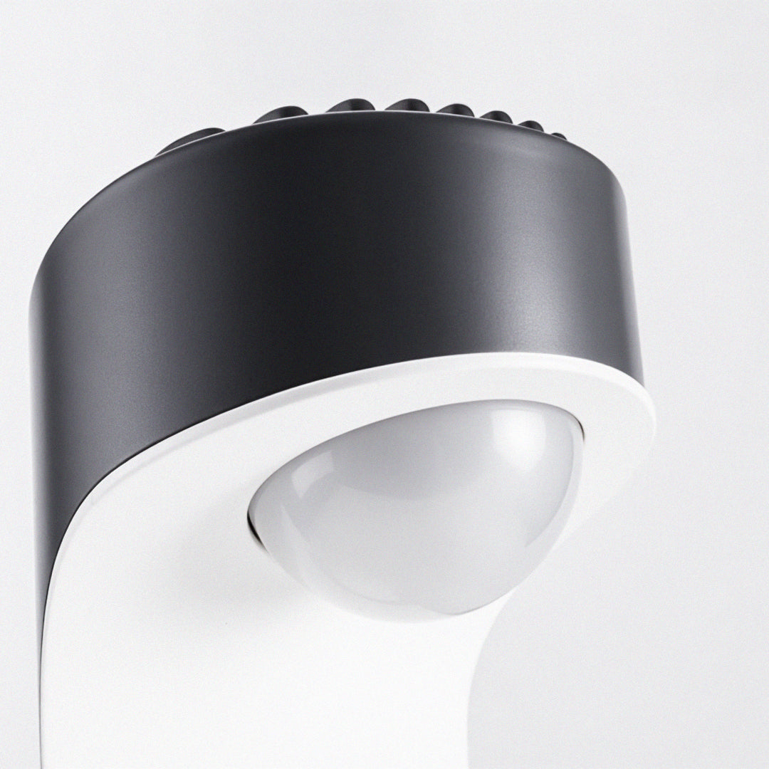 Close-up of modern outdoor wall sconce lighting fixtures with rounded diffuser and black casing.