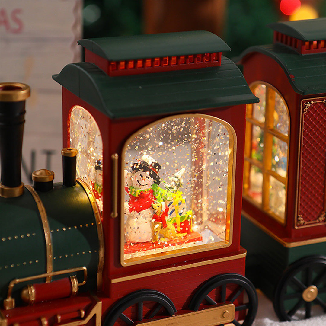 Close-up view of glowing Christmas train lantern featuring Santa inside the cabin.