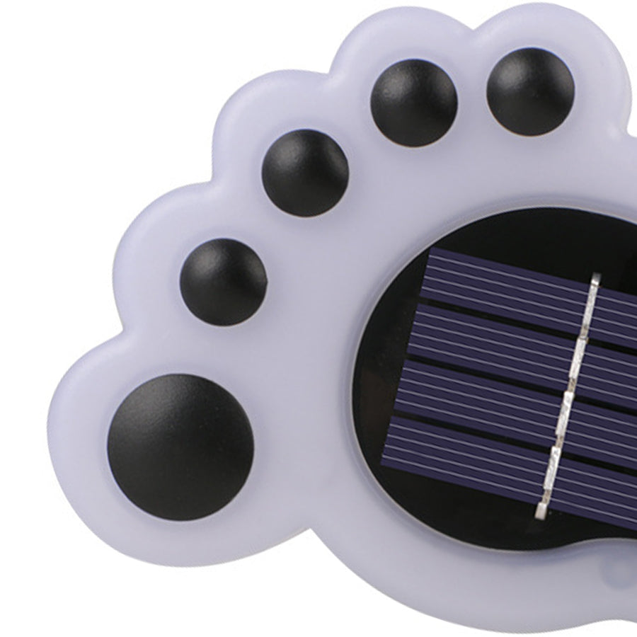 Close-up view of white solar footprint light showing solar panel and design details