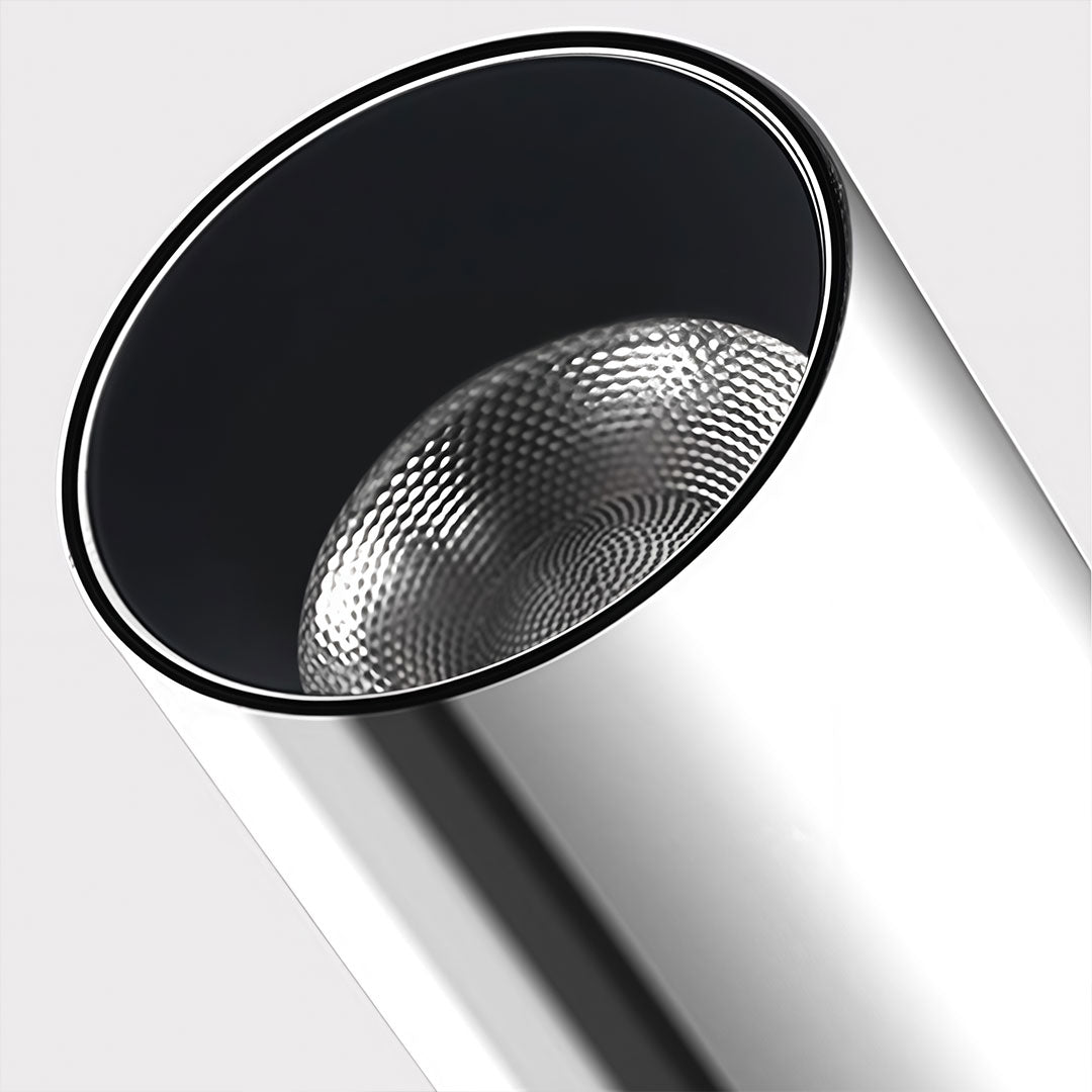 Close-up of spotlight light fixture with sleek metallic design and focus on lens.