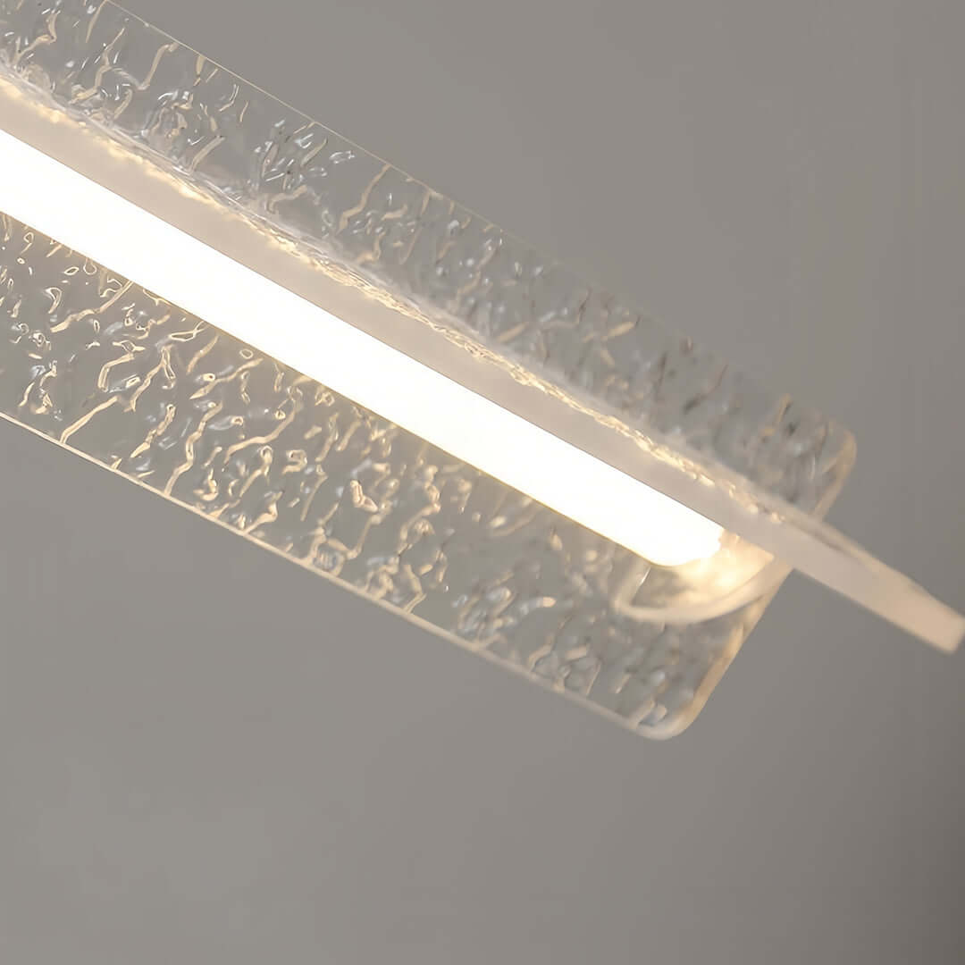 Close-up detail showing the unique textured crystal glass of the modern white pendant light diffuser.