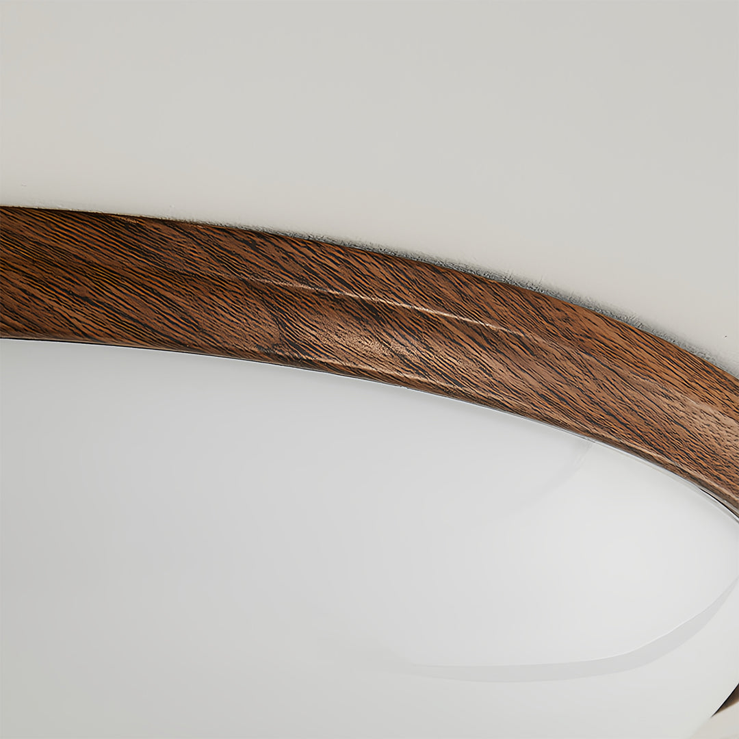 Close-up of vintage art deco flush mount ceiling light edge, detailed wooden trim and texture