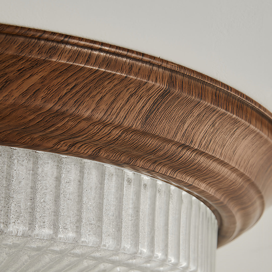 Close-up of vintage art deco flush mount ceiling light edge, detailed view of wooden trim