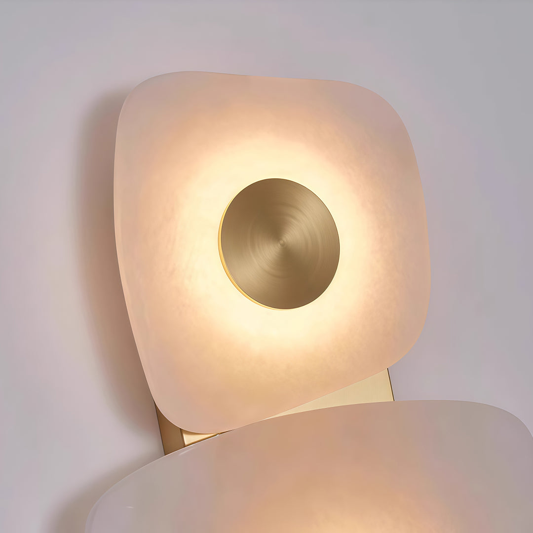 Close-up of wall art lighted featuring glass shade chandelier design showing individual sculptural element with circular LED halo.