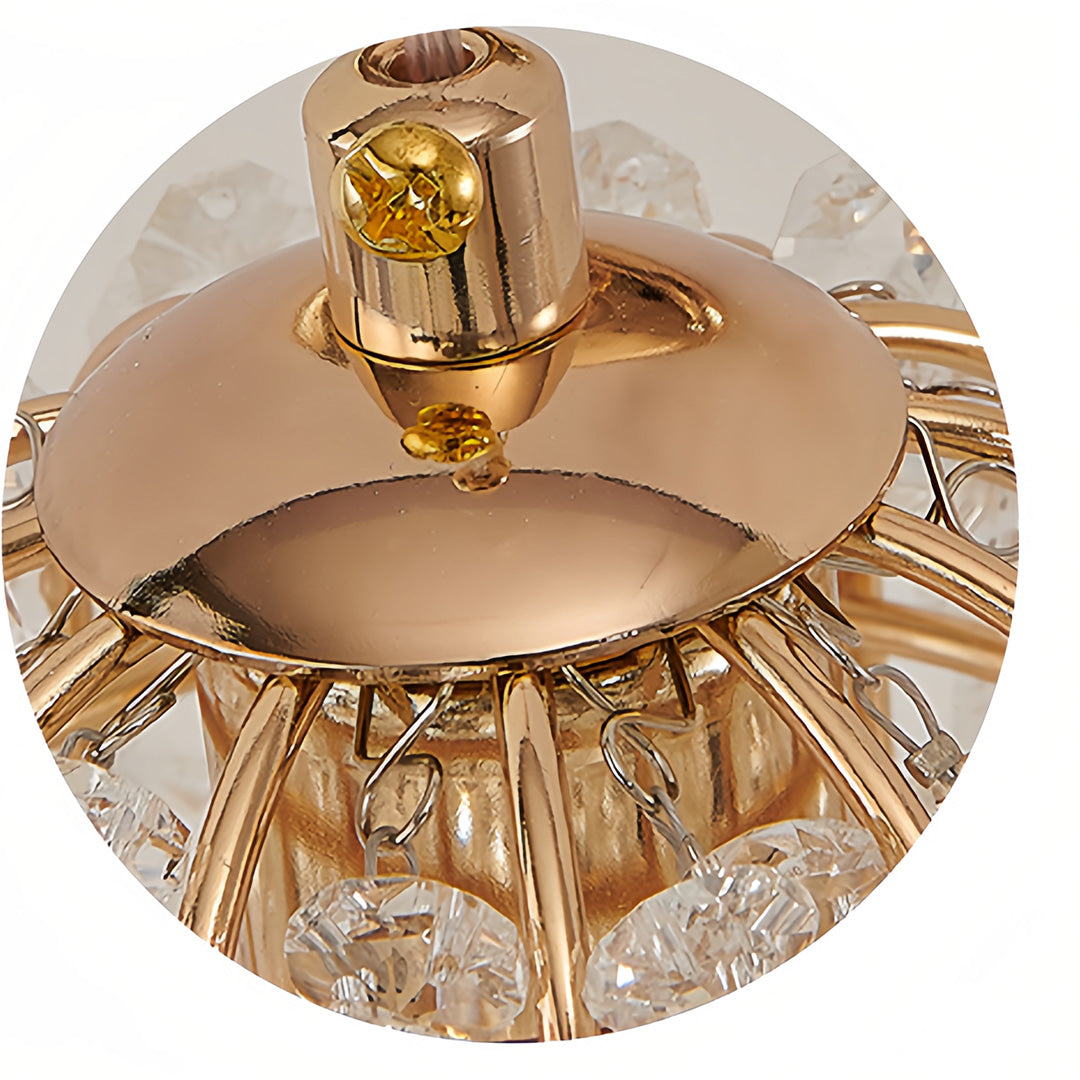 Close-up detail of wall lights with crystals showing glass shade chandelier inspired crystal arrangement and gold mounting hardware.