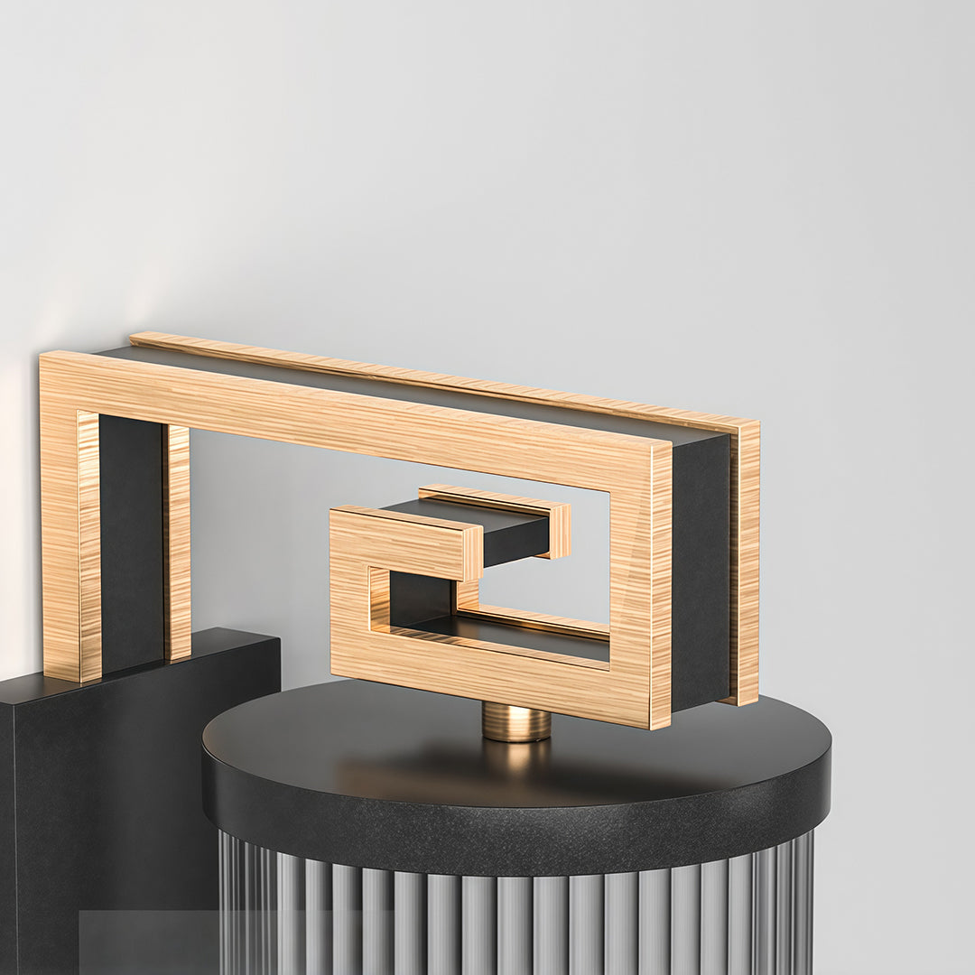 Close-up of wall mounted linear lighting featuring glass shade chandelier styling highlighting fluted glass tube construction detail.