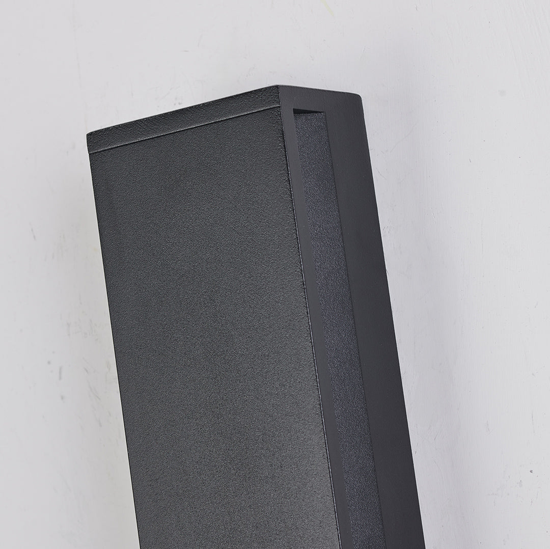 Wall mounted linear lights providing ambient glow in moody interior with lush tropical greenery