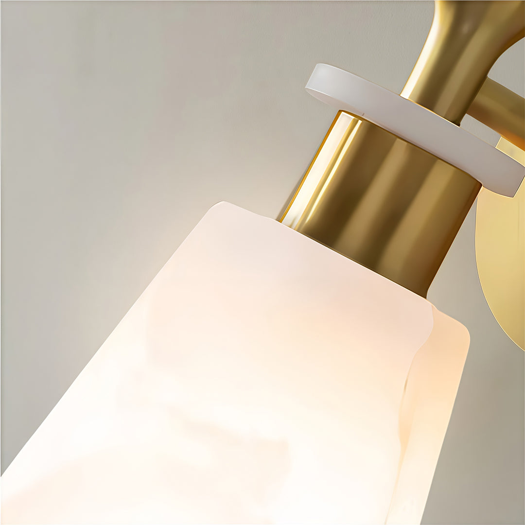Close-up of wall sconce LED light with glass shade chandelier aesthetic highlighting frosted glass shade and gold mounting bracket.