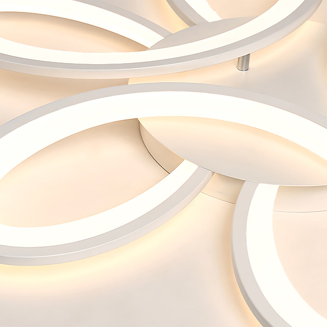 Close-up detail of curved LED light bands in modern ceiling fixture