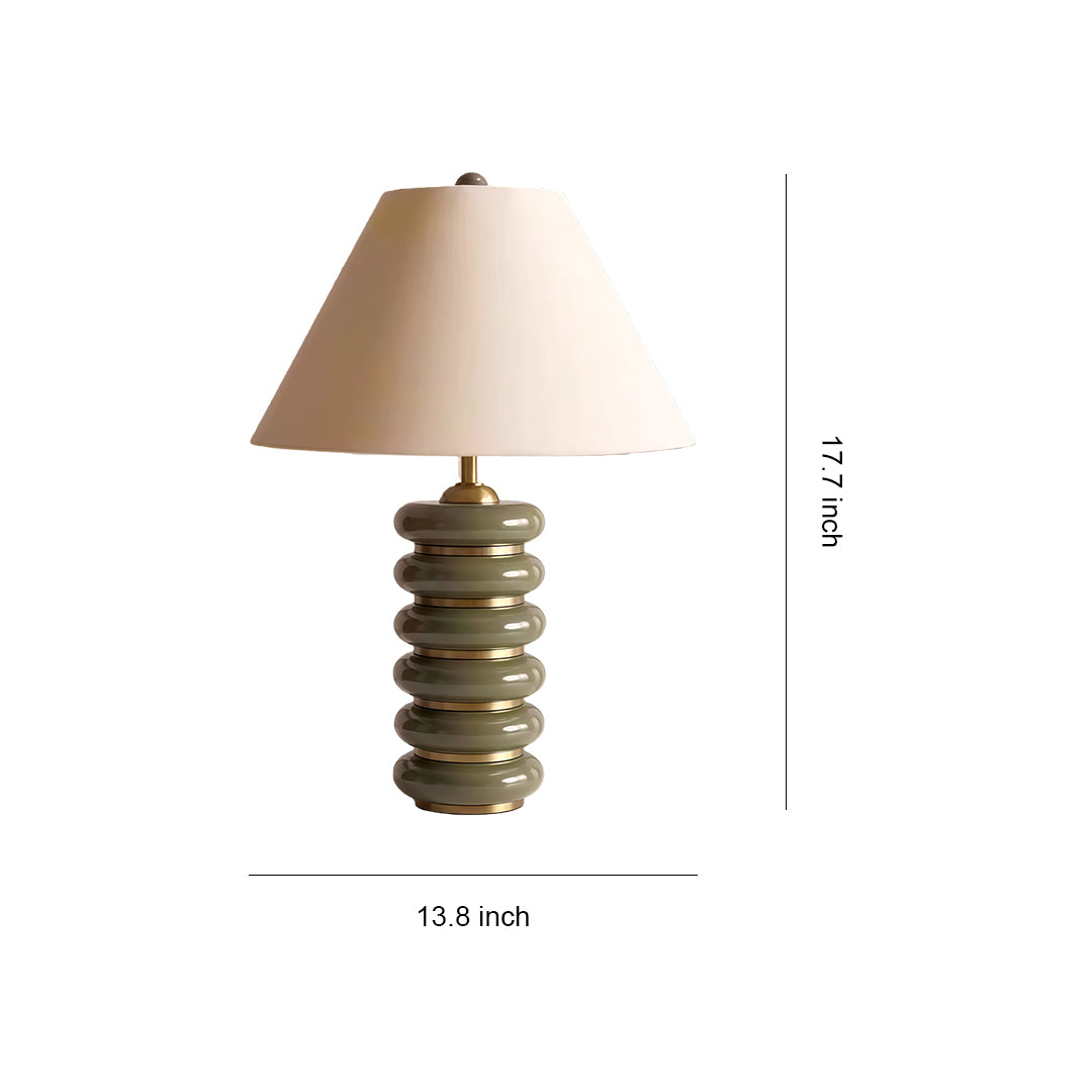 Cloth table lamp with glass shade chandelier inspired design featuring stacked disc base in natural wood tones with cream fabric shade.