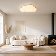Cloud-shaped ceiling light installed in modern living room, soft warm lighting for cozy interior ambiance.