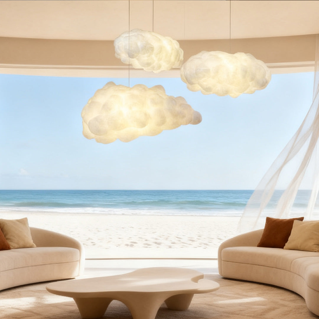 Cloud-inspired pendant light hanging in a coastal living room with ocean view and natural light.