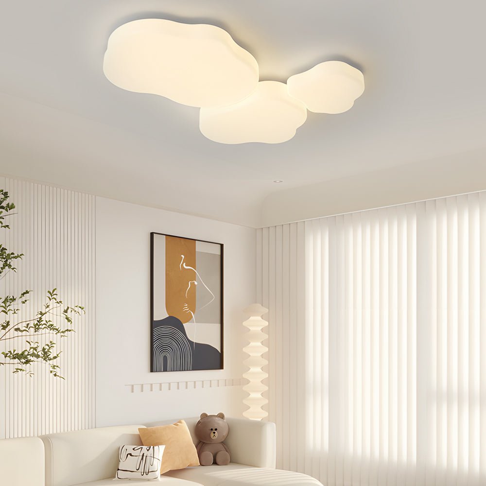 The cloud shaped ceiling light in white complements a light-filled modern living space, adding a touch of softness to the room.