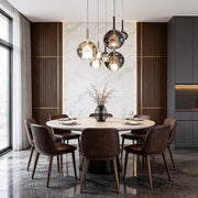 Cluster of glass ball pendant lights hanging above a modern dining table, creating a warm and stylish ambiance.