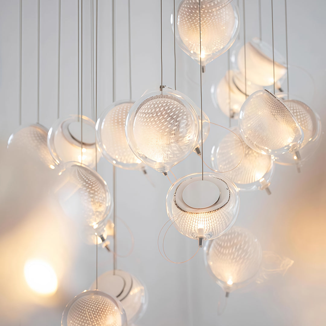 Large installation of jellyfish pendant light with multiple hanging fixtures.
